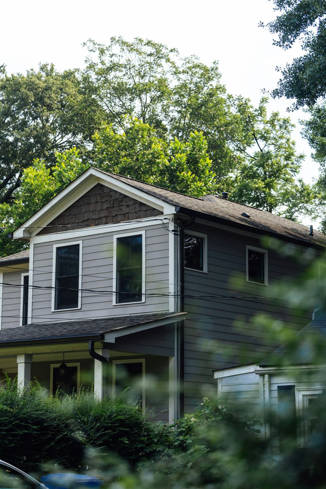 Gray house surrounded by trees